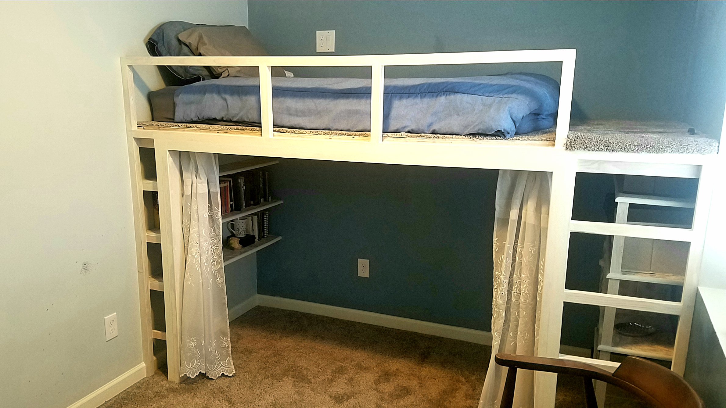 White washed loft bed with sky blue walls