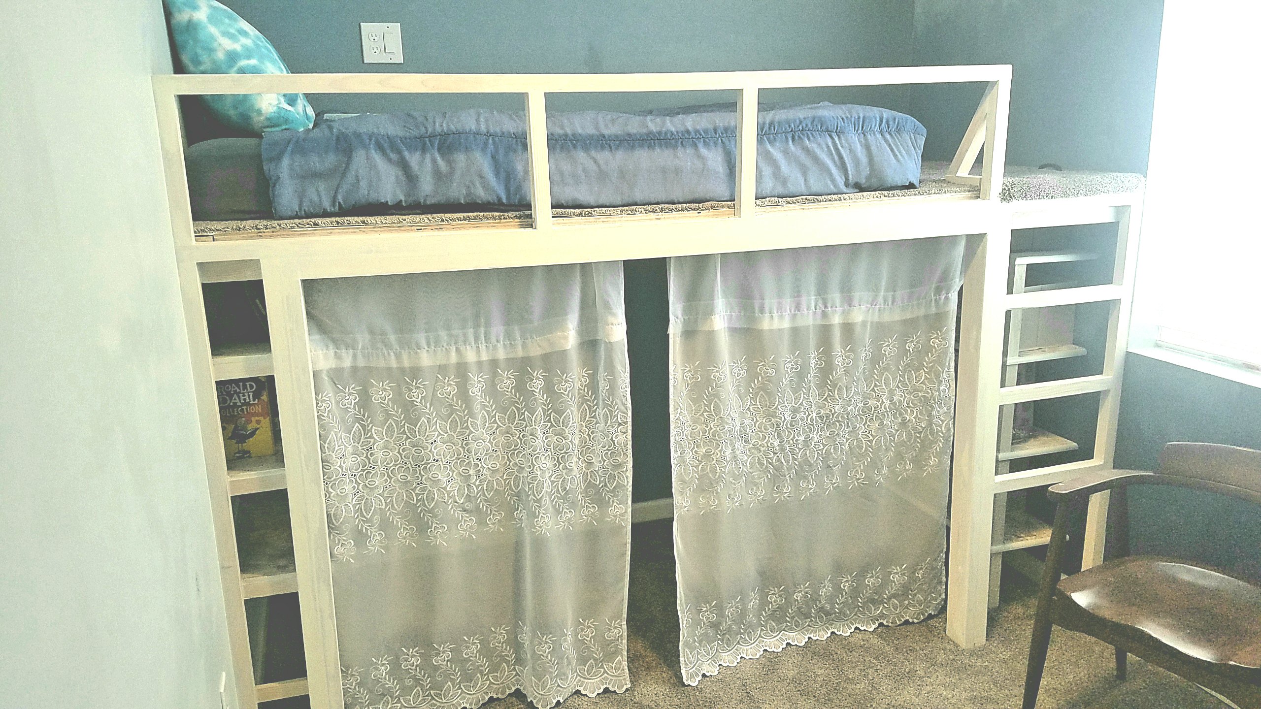 Curtains add a touch of wimsy to this preteen bedroom loft. 