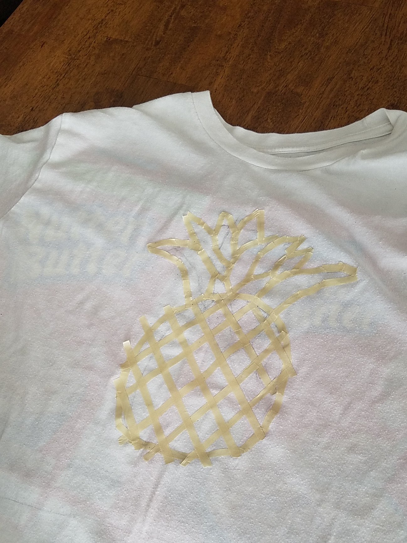 Creating toll paint T-shirt images by using masking tape as a stencil. 